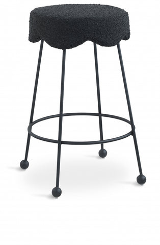 Black bar stool with a textured cushioned seat on a white background