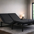 Ergomotion DUETTO Split Top Adjustable Bed in a room with lamps and a window.