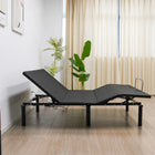 Ergomotion RIO 2.0 Adjustable Bed in a room with plants and a wooden side table.