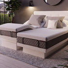 DawnHouse bed with gray cushions on a patio with plants and a mountain view.