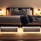 DawnHouse bed with pillows, and lamps on a wooden floor.