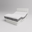 Mattress on a white bed frame against a gray background