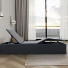 Ergomotion STOW Storage Adjustable Bed in a room with large windows and curtains.