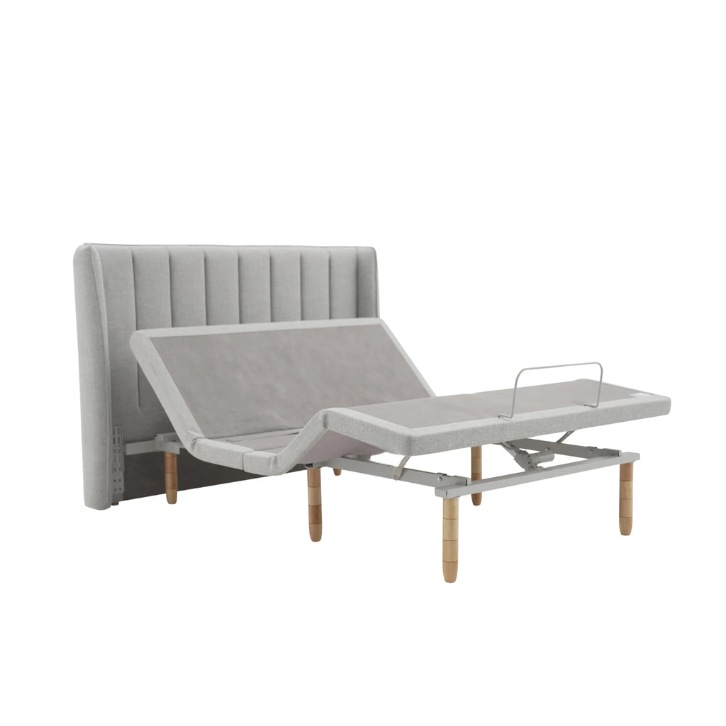 Ergomotion SmartSense gray adjustable bed with traditional headboard on a white background